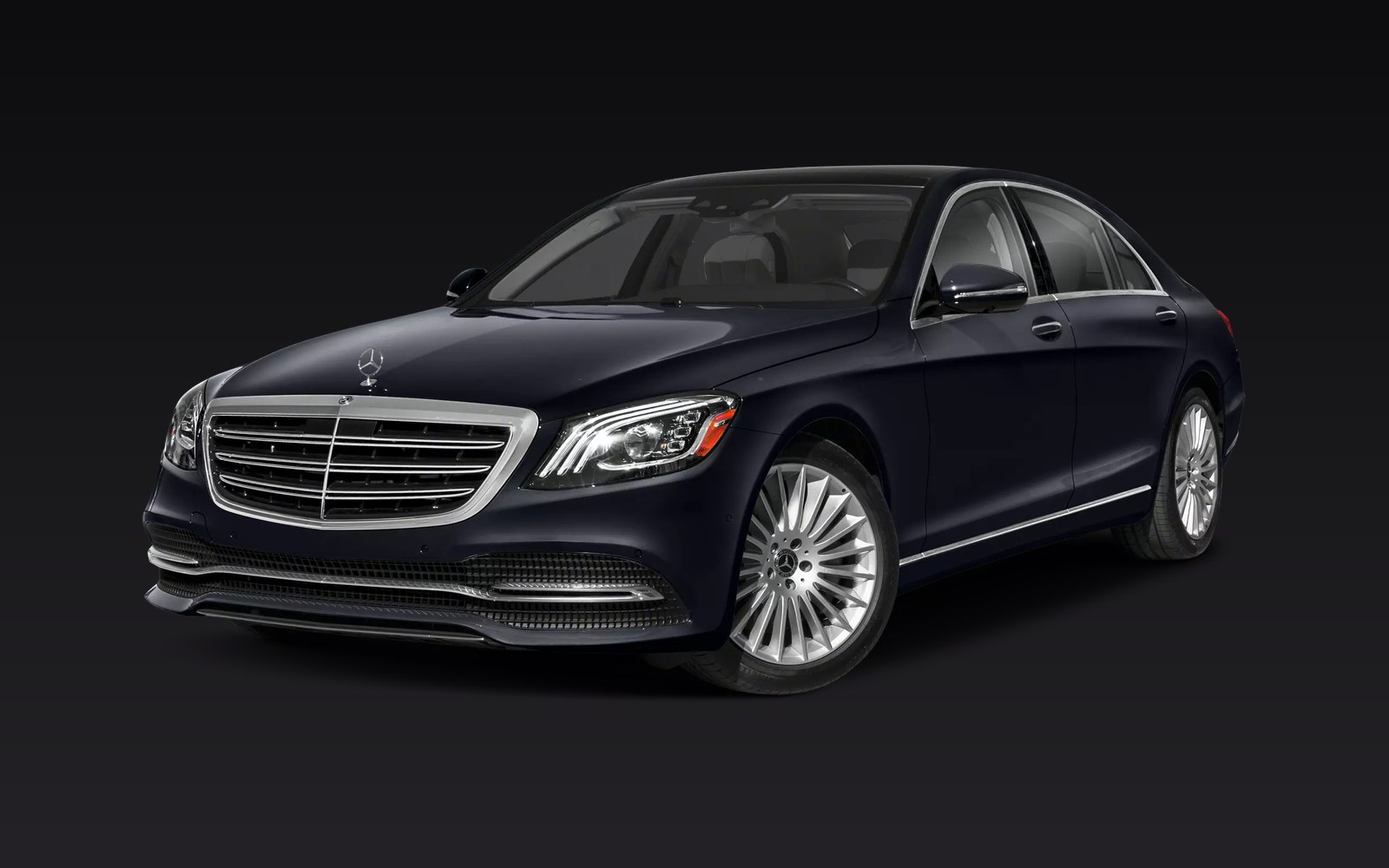 Professional chauffeur opening the door of a black luxury sedan
